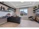 Well-lit home office featuring a dark desk, stylish decor, floating shelves, and a large window with neighborhood views at 4789 Terrace Bluff St, Winter Garden, FL 34787