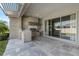 A well-appointed outdoor kitchen featuring stone detailing, stainless steel grill, and a covered patio area at 4789 Terrace Bluff St, Winter Garden, FL 34787