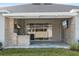 Covered patio with an outdoor kitchen, stainless steel grill, and a built-in television for outdoor entertaining at 4789 Terrace Bluff St, Winter Garden, FL 34787