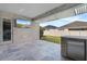 Covered outdoor kitchen with a built-in grill, stainless steel appliances, and a view of the backyard at 4789 Terrace Bluff St, Winter Garden, FL 34787