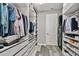 Organized walk-in closet with shelving and storage for clothes and shoes at 4789 Terrace Bluff St, Winter Garden, FL 34787