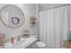 Bright bathroom features a vanity sink, toilet, and shower-tub combination with coastal-themed decor at 4816 Cliveden Loop, Sanford, FL 32773