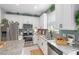 Well-lit kitchen features granite countertops, stainless steel appliances, and white cabinetry at 4816 Cliveden Loop, Sanford, FL 32773