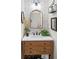 Chic powder room featuring a wooden vanity, stylish mirror, and elegant wallpaper at 4816 Cliveden Loop, Sanford, FL 32773