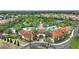 Aerial view showcases resort-style pool, clubhouse, and lush landscaping in a vibrant community setting at 5234 Wildwood Way, Davenport, FL 33837