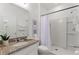 Clean and modern bathroom featuring a granite countertop vanity and a tiled stand-up shower at 5234 Wildwood Way, Davenport, FL 33837