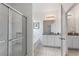 Bright bathroom featuring double vanities with granite countertops and large glass-enclosed shower at 5234 Wildwood Way, Davenport, FL 33837