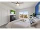 Inviting bedroom featuring a large window view, a TV, and a bed with white linens and pillows at 5234 Wildwood Way, Davenport, FL 33837