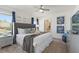 Elegant bedroom featuring a grey upholstered headboard bed, decorative pillows, and stylish accents at 5234 Wildwood Way, Davenport, FL 33837