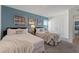 Bedroom highlighting two twin beds with soft white comforters and an ocean blue accent wall at 5234 Wildwood Way, Davenport, FL 33837