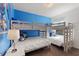 bedroom with bunk beds, blue accent wall, and a Frozen theme at 5234 Wildwood Way, Davenport, FL 33837