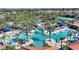 Aerial view of community pool area with lazy river, slide, waterfall and tropical landscaping at 5234 Wildwood Way, Davenport, FL 33837