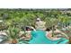 Aerial view of community pool featuring a waterfall, slide and palm trees at 5234 Wildwood Way, Davenport, FL 33837