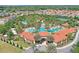 Aerial view of community pool area with multiple pools, waterslide, lounge chairs and landscaping at 5234 Wildwood Way, Davenport, FL 33837