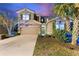 Beautiful home exterior displaying lush landscaping, a driveway, and a well-maintained facade at 5234 Wildwood Way, Davenport, FL 33837