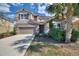 Beautiful two-story home featuring a well-manicured lawn, desert landscaping, tile roof, and two car garage at 5234 Wildwood Way, Davenport, FL 33837