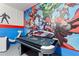 Spacious game room featuring an air hockey table and vibrant Marvel-themed wall art at 5234 Wildwood Way, Davenport, FL 33837