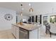 Kitchen island boasts granite countertops, a stainless steel dishwasher, and pendant lighting at 5234 Wildwood Way, Davenport, FL 33837