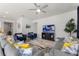 Relaxing living room with sectional sofa and entertainment center, seamlessly connecting to other living spaces at 5234 Wildwood Way, Davenport, FL 33837