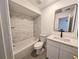 Updated bathroom showcasing a tub with tiled walls, modern vanity, and contemporary fixtures, creating a stylish space at 5415 Fairwood Way # 303, Orlando, FL 32808