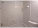 Bathroom with a tiled shower and tub, along with a toilet and towel rack at 5415 Fairwood Way # 303, Orlando, FL 32808