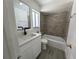 Bathroom featuring modern vanity, square mirror and new fixtures, and tiled shower with neutral walls at 5415 Fairwood Way # 303, Orlando, FL 32808