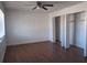 Spacious bedroom with wood floors, ceiling fan, and closet space at 5415 Fairwood Way # 303, Orlando, FL 32808