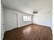 Bright bedroom with new laminate flooring, ceiling fan, and door to the outside at 5415 Fairwood Way # 303, Orlando, FL 32808