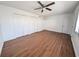 Large bedroom with laminate flooring, ceiling fan, and ample closet space, ideal for comfortable living at 5415 Fairwood Way # 303, Orlando, FL 32808