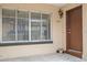 Close up of the front door, showing the house number, window and light fixture at 5415 Fairwood Way # 303, Orlando, FL 32808