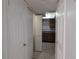 Hallway view looking into the kitchen with cabinets and appliances at 5415 Fairwood Way # 303, Orlando, FL 32808