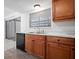 Bright kitchen features wood cabinets, modern countertops, and stainless steel dishwasher at 5415 Fairwood Way # 303, Orlando, FL 32808