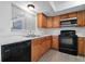 Updated kitchen with stainless steel appliances, wood cabinets, and granite countertops at 5415 Fairwood Way # 303, Orlando, FL 32808