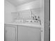 Laundry room equipped with a washer, dryer, and wire shelving at 5415 Fairwood Way # 303, Orlando, FL 32808