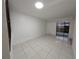 Spacious living area featuring tiled flooring and access to the outdoors at 5415 Fairwood Way # 303, Orlando, FL 32808