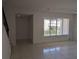 Living room with tile floors, bright window, and staircase view at 5415 Fairwood Way # 303, Orlando, FL 32808