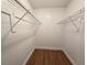 Spacious walk-in closet featuring built-in wire shelving and wood-look vinyl flooring, ready for organizing clothes at 5415 Fairwood Way # 303, Orlando, FL 32808