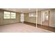 Basement featuring carpeted floors, wood paneling, and windows for natural lighting at 623 Camellia Ct, Sanford, FL 32773