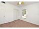 Bedroom with tan carpet, white walls and trim, and a ceiling fan at 623 Camellia Ct, Sanford, FL 32773