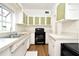 Well-lit kitchen featuring light countertops, wood flooring, and modern appliances at 623 Camellia Ct, Sanford, FL 32773