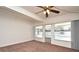 Bright living room with carpet and a view of the pool through expansive windows at 623 Camellia Ct, Sanford, FL 32773