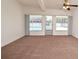 Bright living room with carpet and a view of the pool through large windows at 623 Camellia Ct, Sanford, FL 32773