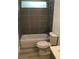 Cozy bathroom featuring tiled shower and gray vanity with light wood flooring at 6937 Se 23 Ave, Ocala, FL 34480