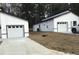 Exterior view of modern homes and garages, surrounded by lawns and trees at 6937 Se 23 Ave, Ocala, FL 34480