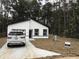 New construction home featuring black trimmed windows and garage with a well manicured lawn at 6937 Se 23 Ave, Ocala, FL 34480