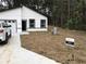 New construction home featuring black trimmed windows and garage with a well manicured lawn at 6937 Se 23 Ave, Ocala, FL 34480