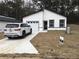 New construction home featuring black trimmed windows and garage with a well manicured lawn at 6937 Se 23 Ave, Ocala, FL 34480