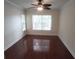 Bedroom with hardwood flooring, a ceiling fan, and natural light from large windows at 713 Crest Pines Dr # 227, Orlando, FL 32828