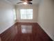 Well-lit bedroom with hardwood flooring and windows providing natural light at 713 Crest Pines Dr # 227, Orlando, FL 32828