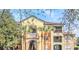 Colorful condominium exterior showing balconies and stairs surrounded by lush Florida landscaping and palm trees at 713 Crest Pines Dr # 227, Orlando, FL 32828